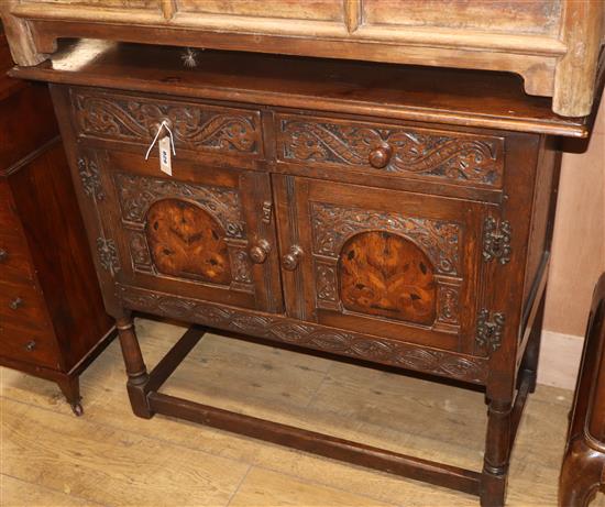 A small 17th century style inlaid oak cupboard W.98cm